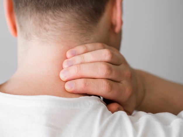 Man rubbing neck to relieve tech neck pain