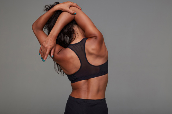 Woman stretching with her back to the camera