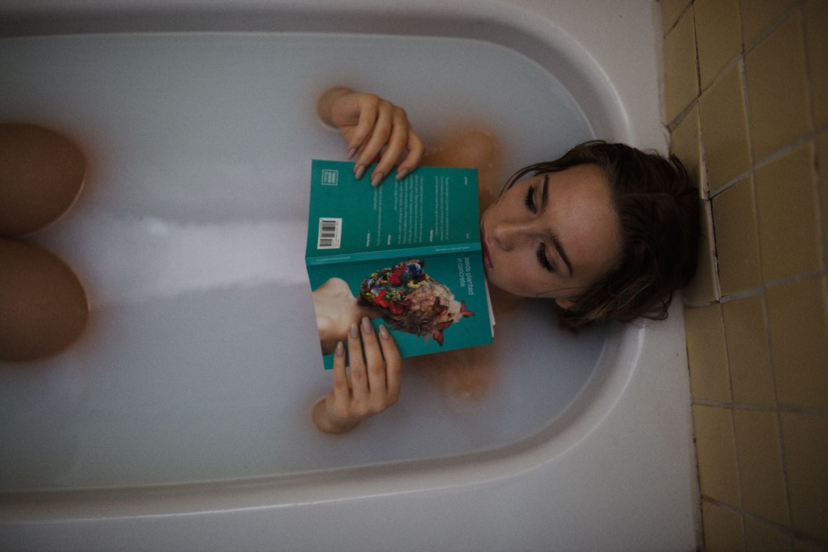 A woman taking a bath with Epsom salts for sore muscles